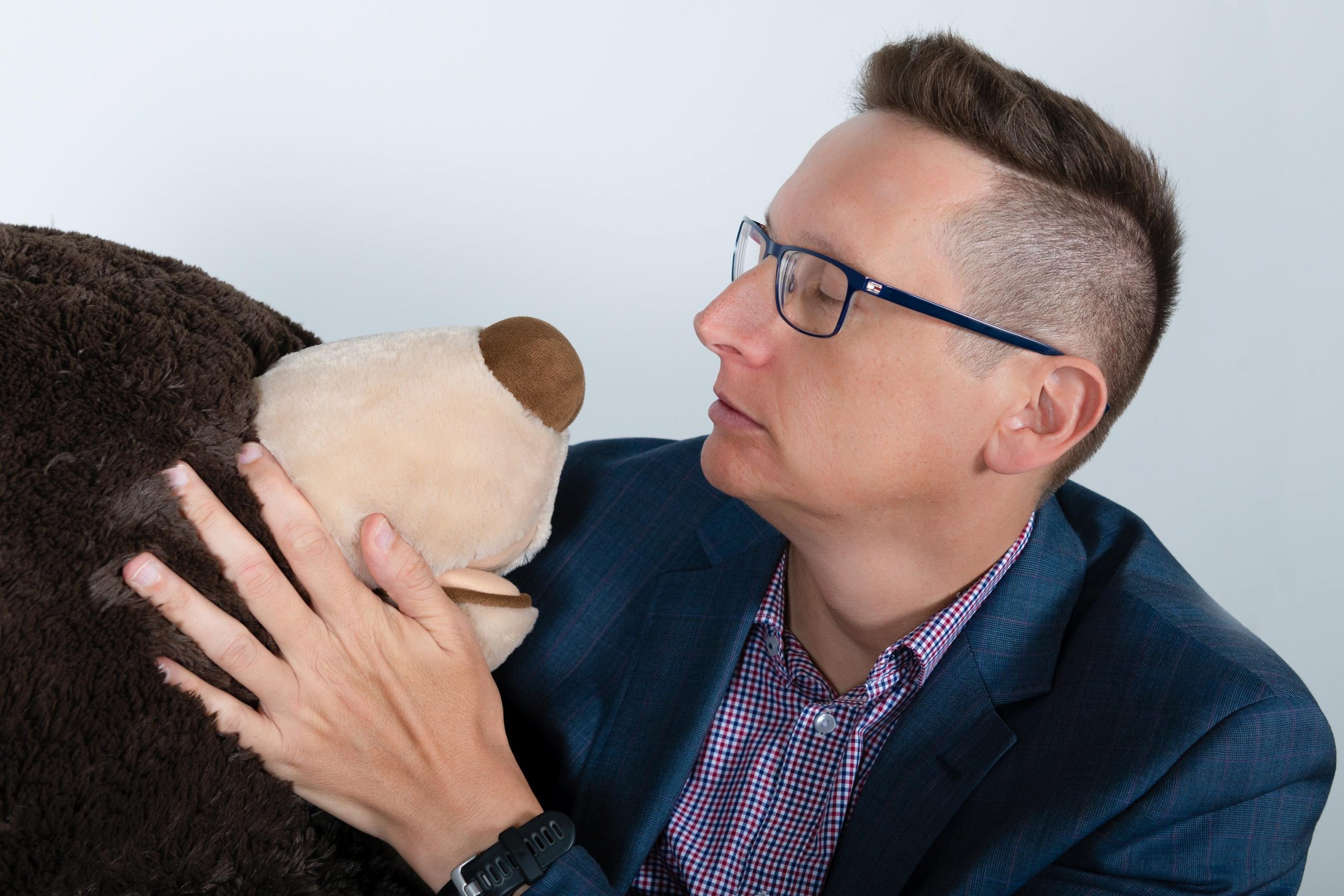 man holding stuffed bear