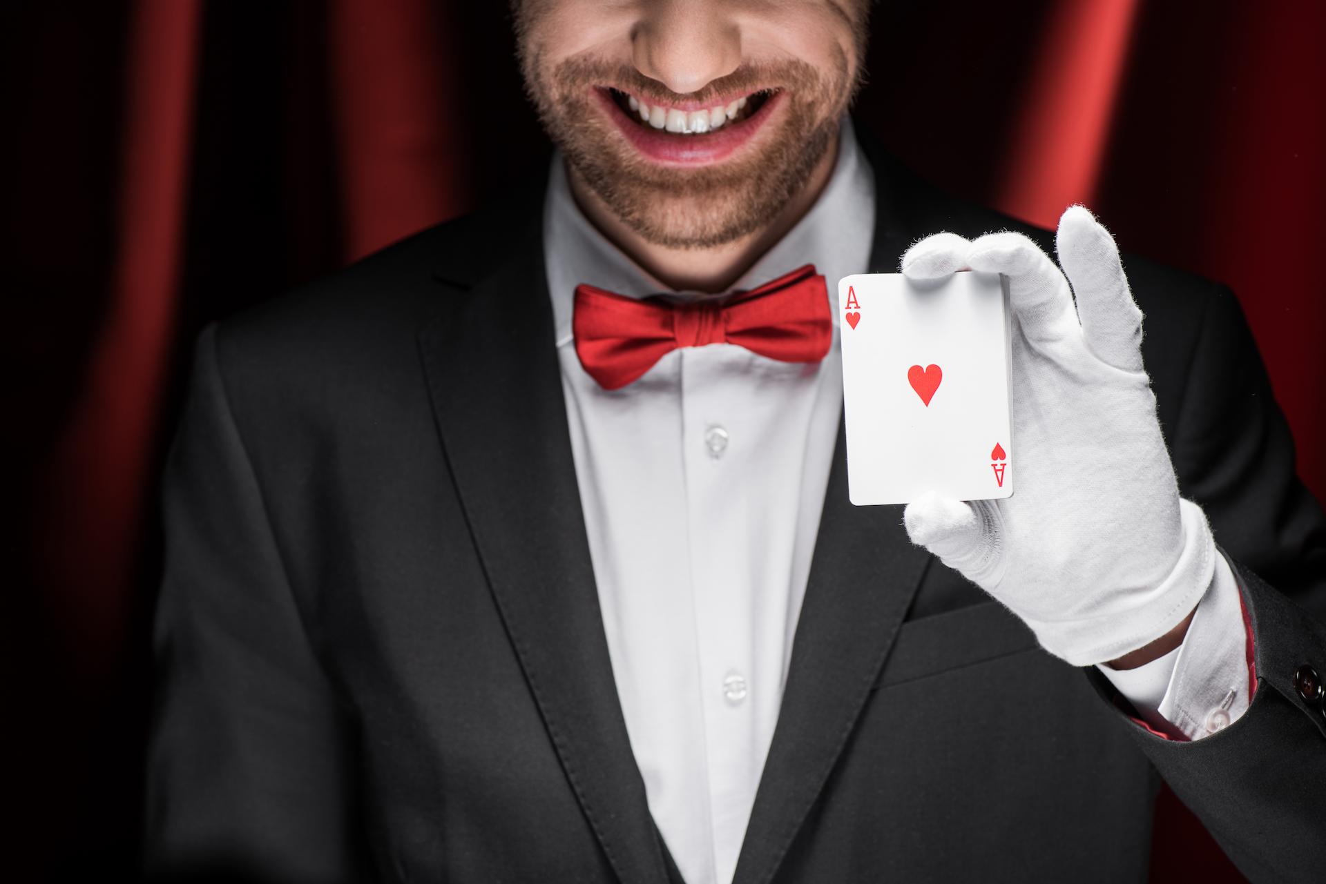 magician holing a card