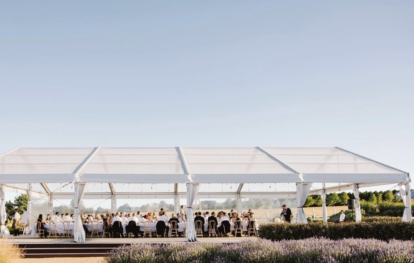 Mona Farm wedding venue with clear marquee reception, long tables and estate garden views.