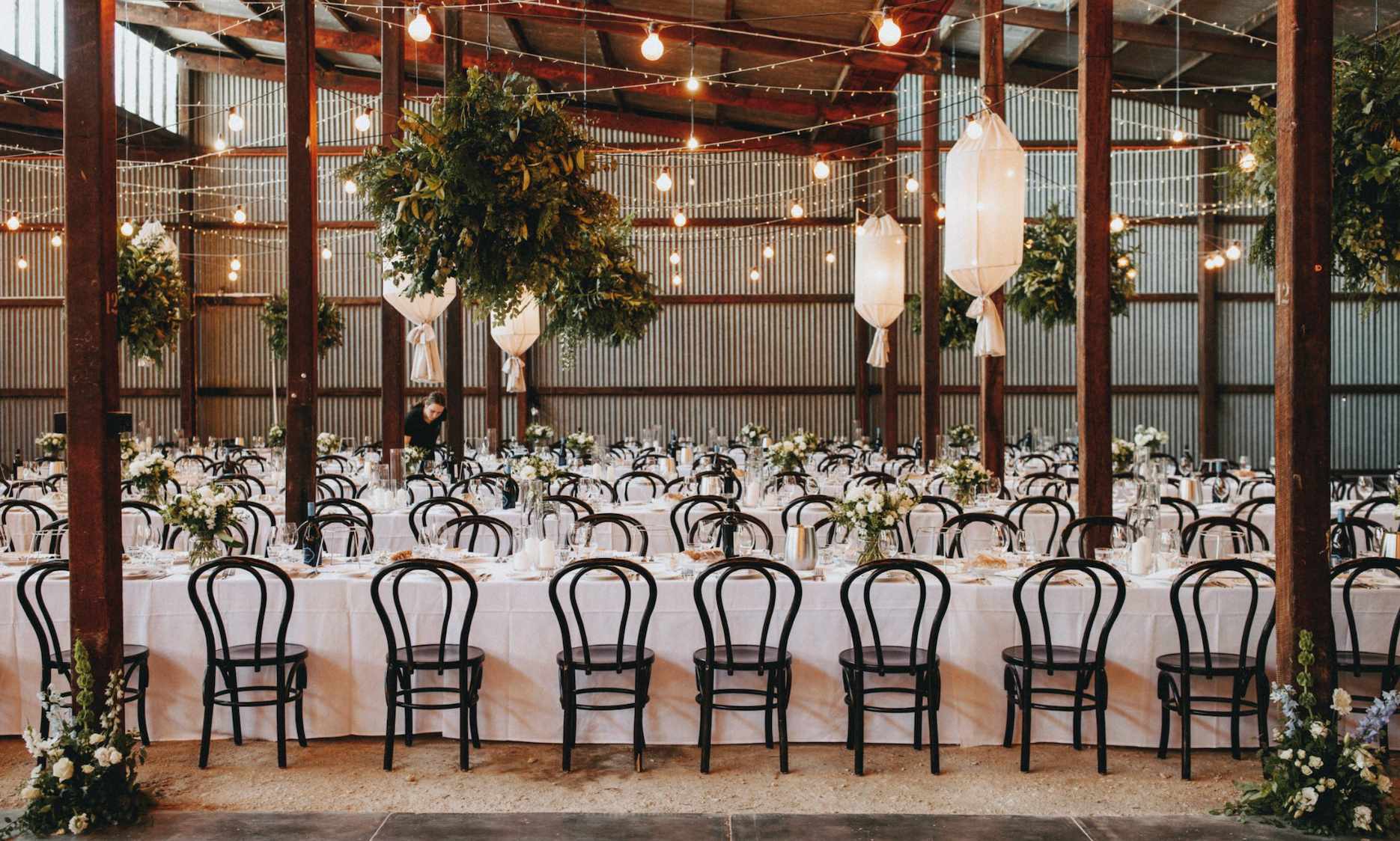 Seppeltsfield wedding venue reception with long tables, floral installations and warm hanging lights.