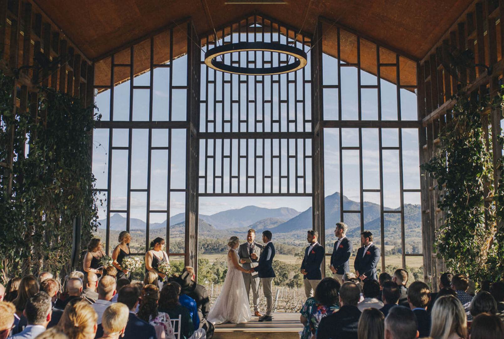 Wet weather wedding ceremony setup at Kooroomba Vineyard and Lavender Farm with mountain views.