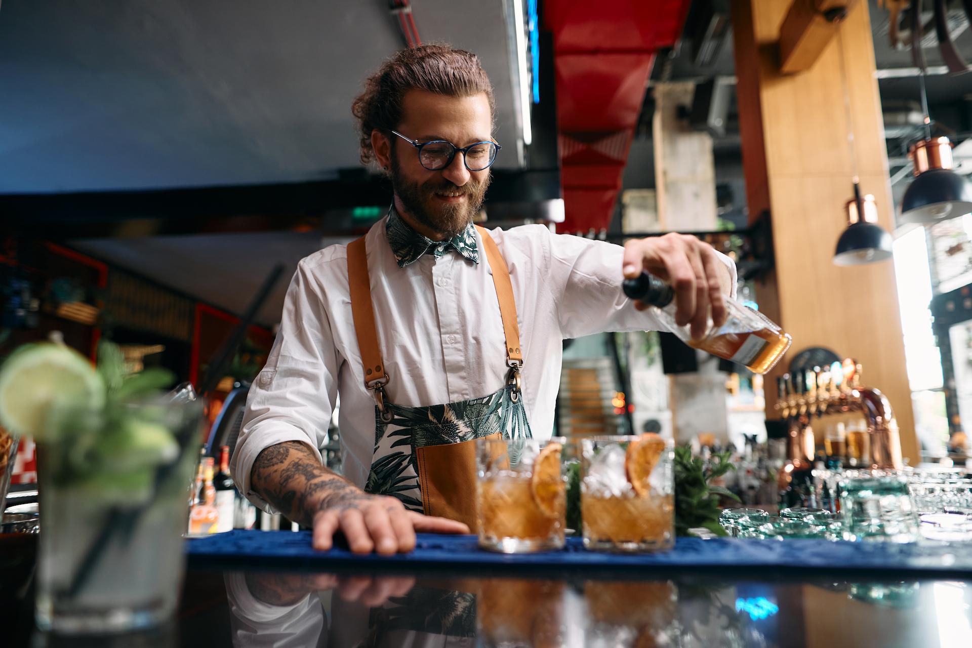 Bar man pouring drinks at a corporate cocktail themed party