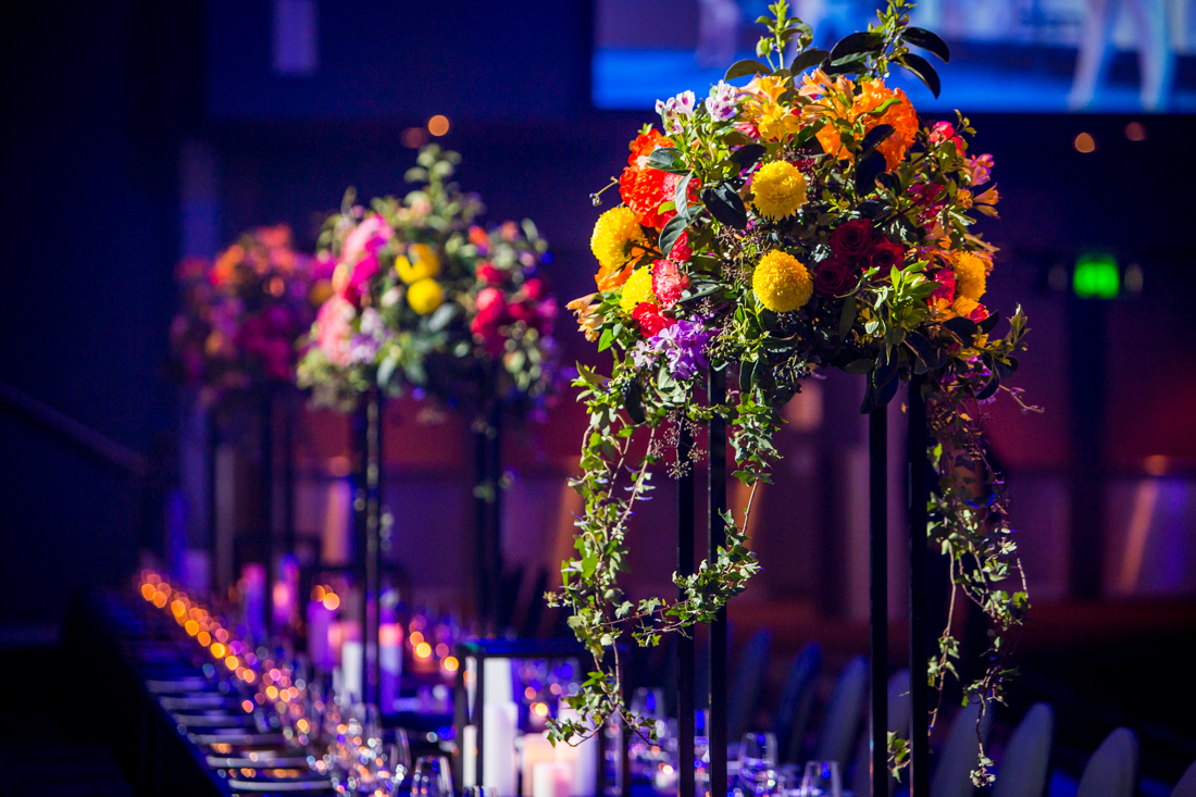 Photo Of Floral Arrangements At A Gala Dinner Table Setting