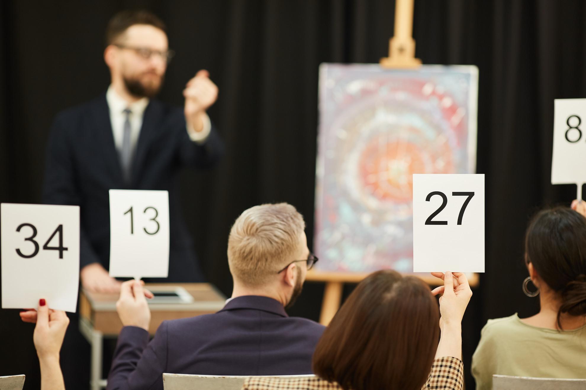 Guests raising bidding cards during a live charity auction.