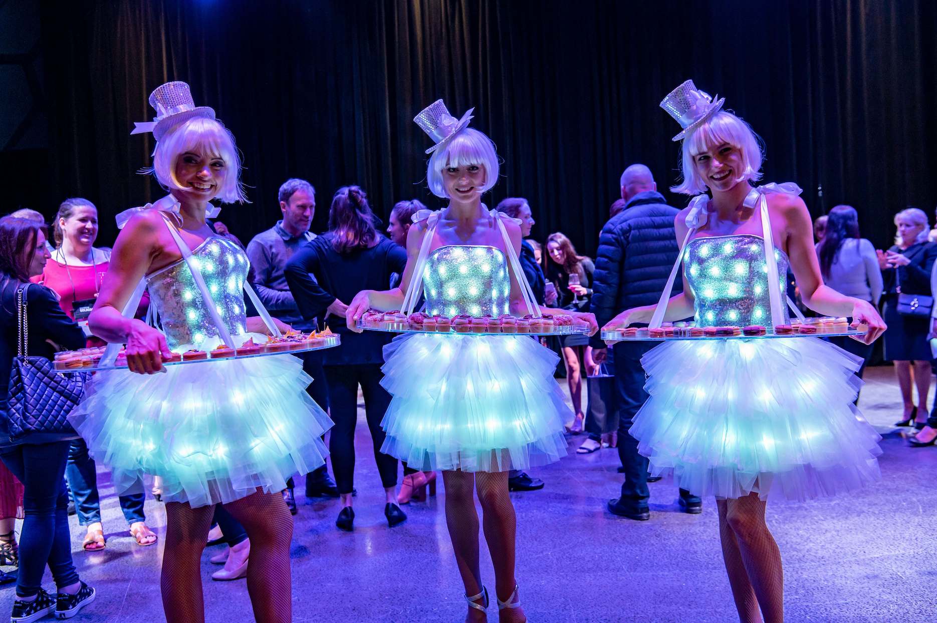 LED costume performers serving guests during a colourful wedding reception.