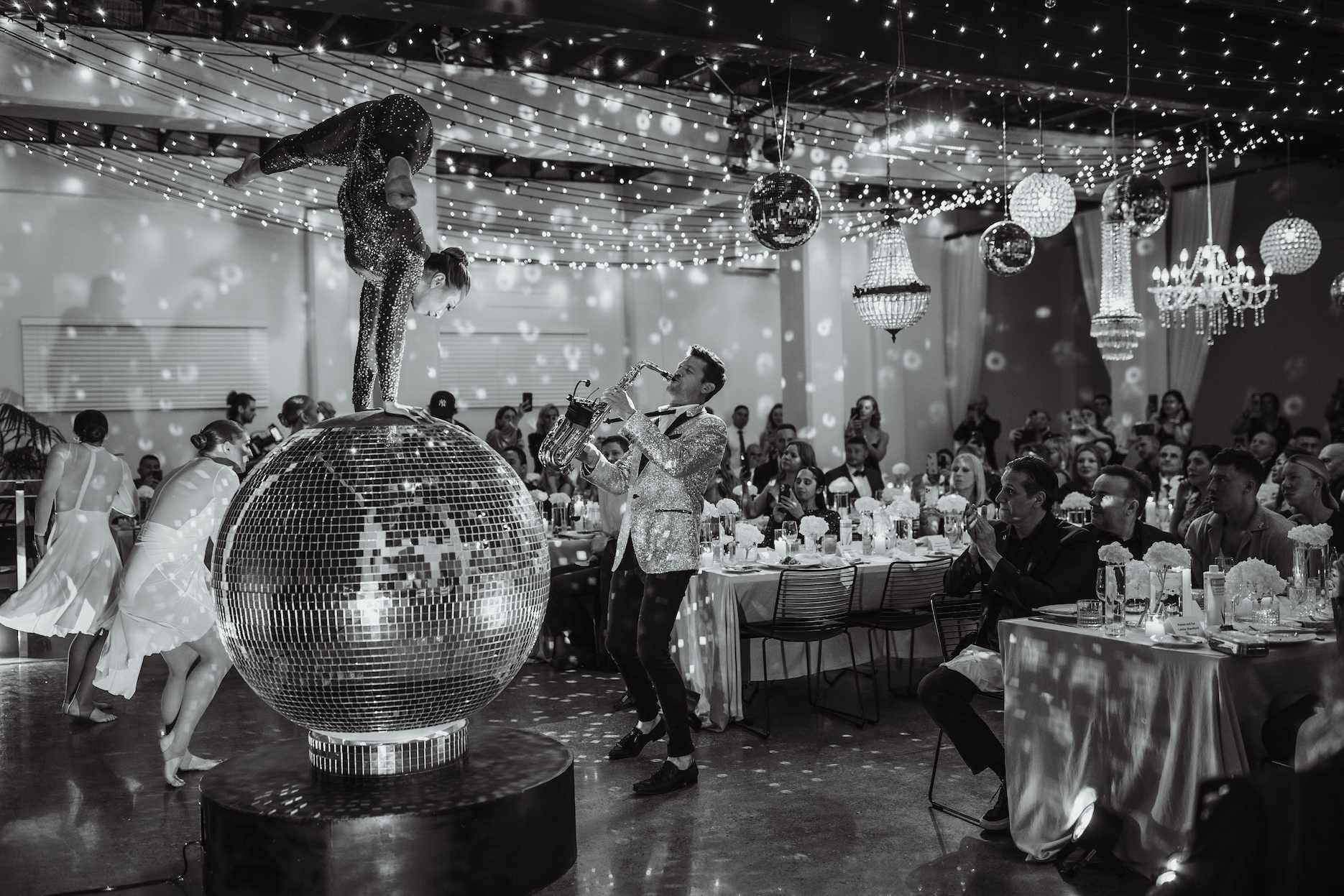 Disco-themed gala dinner with acrobat, saxophonist and mirror-ball entertainment.