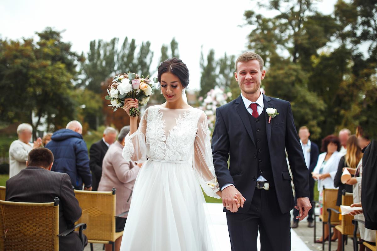 A couple walking down the isle at their Brisbane wedding. 