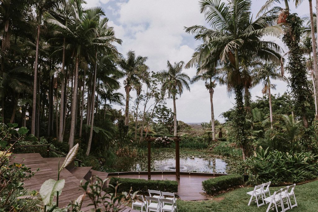 Rainforest Gardens Brisbane wedding venue with tropical palms, garden ceremony seating and a lakeside ceremony arbour.