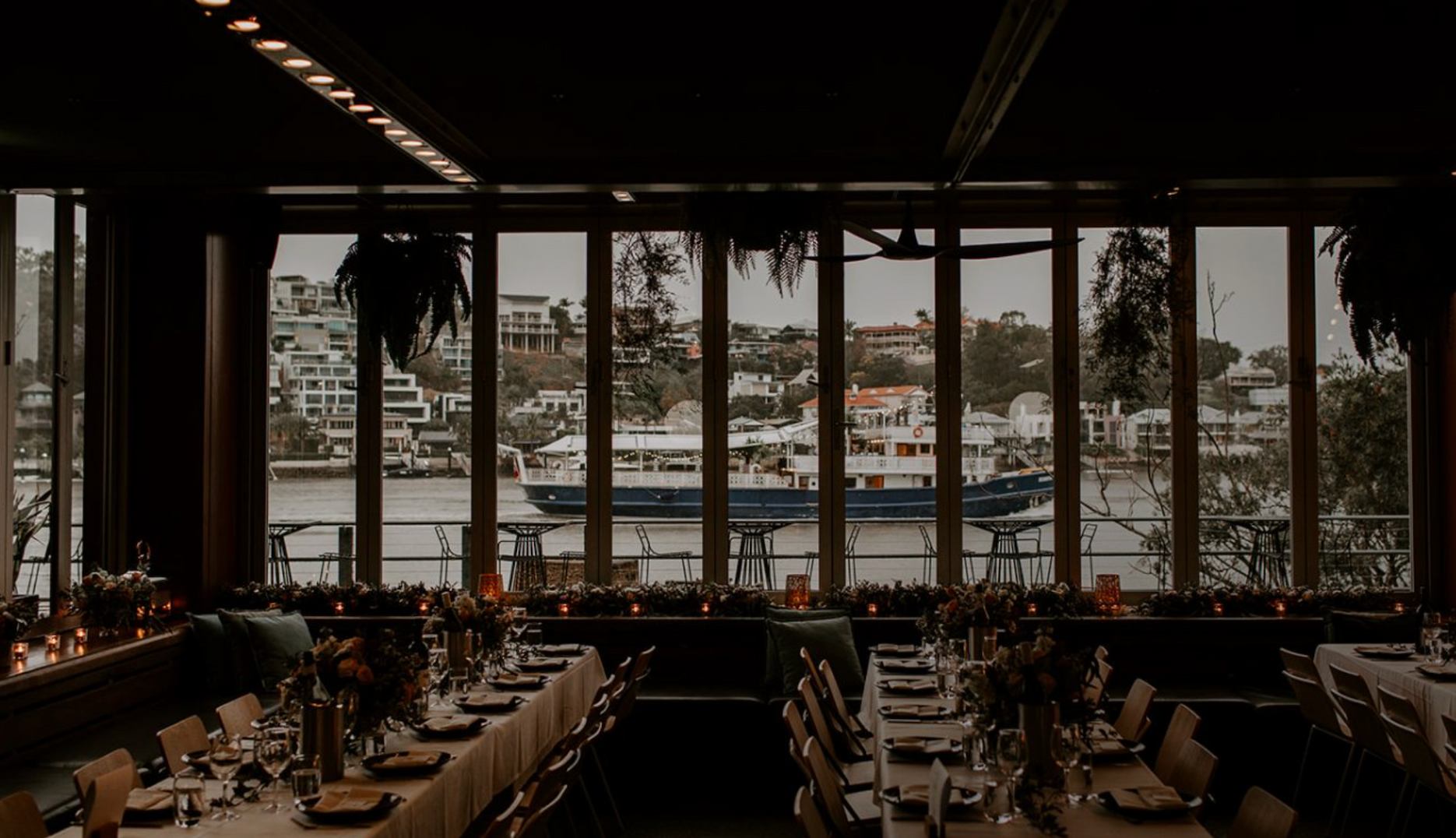 Wedding reception at Mary Mae’s Brisbane with long table dining, river views and New Farm waterfront backdrop.