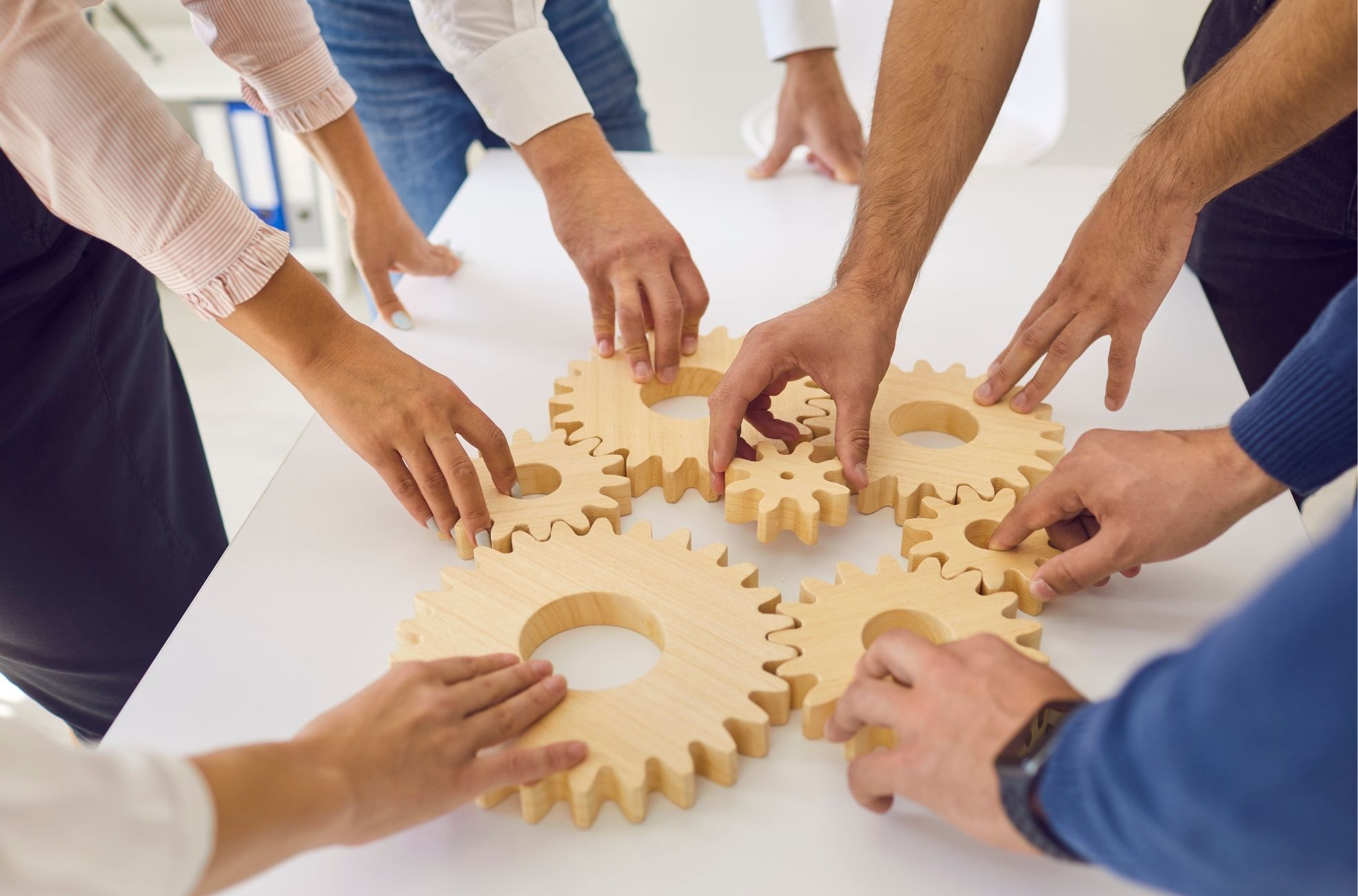 Team Building Hands And Wooden Cogs