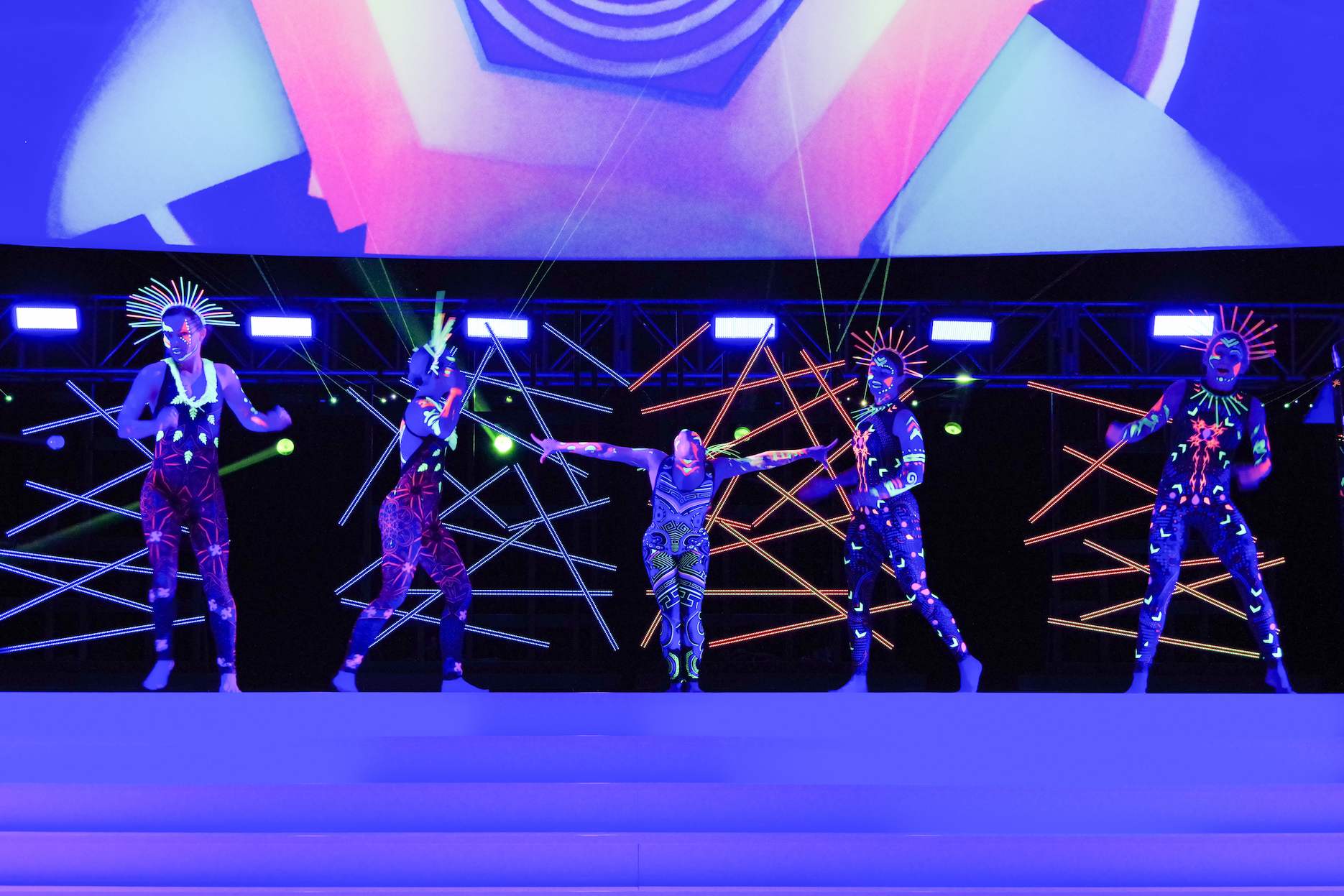 LED dancers performing a high-impact feature act on stage at a corporate party.