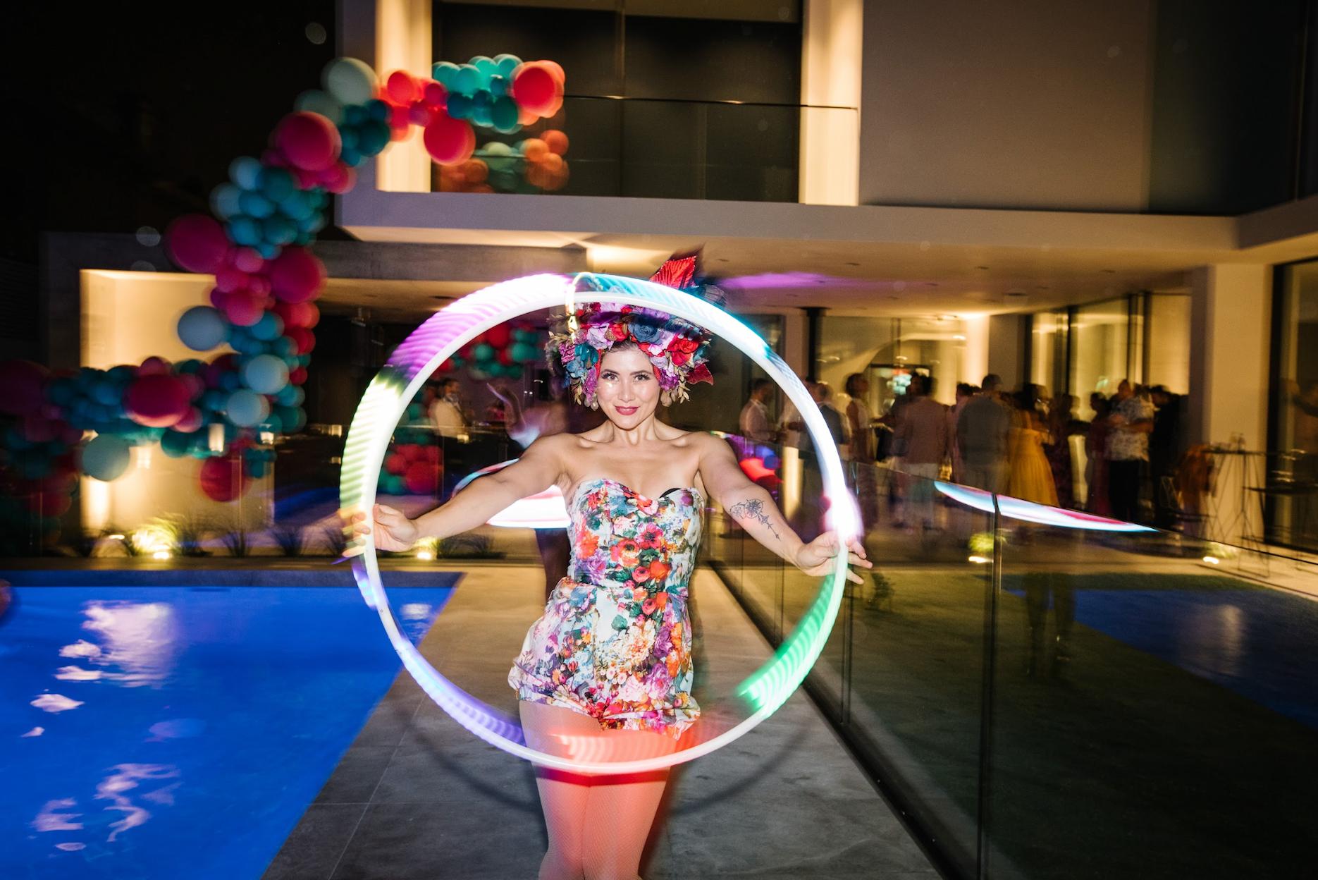 How-to-Plan-a-Birthday-Party-1 LED hoop performer entertaining guests at a colourful birthday party.