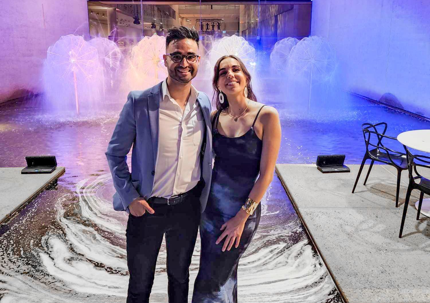 Brisbane wedding band duo act Uncovered posing in front of a water feature.