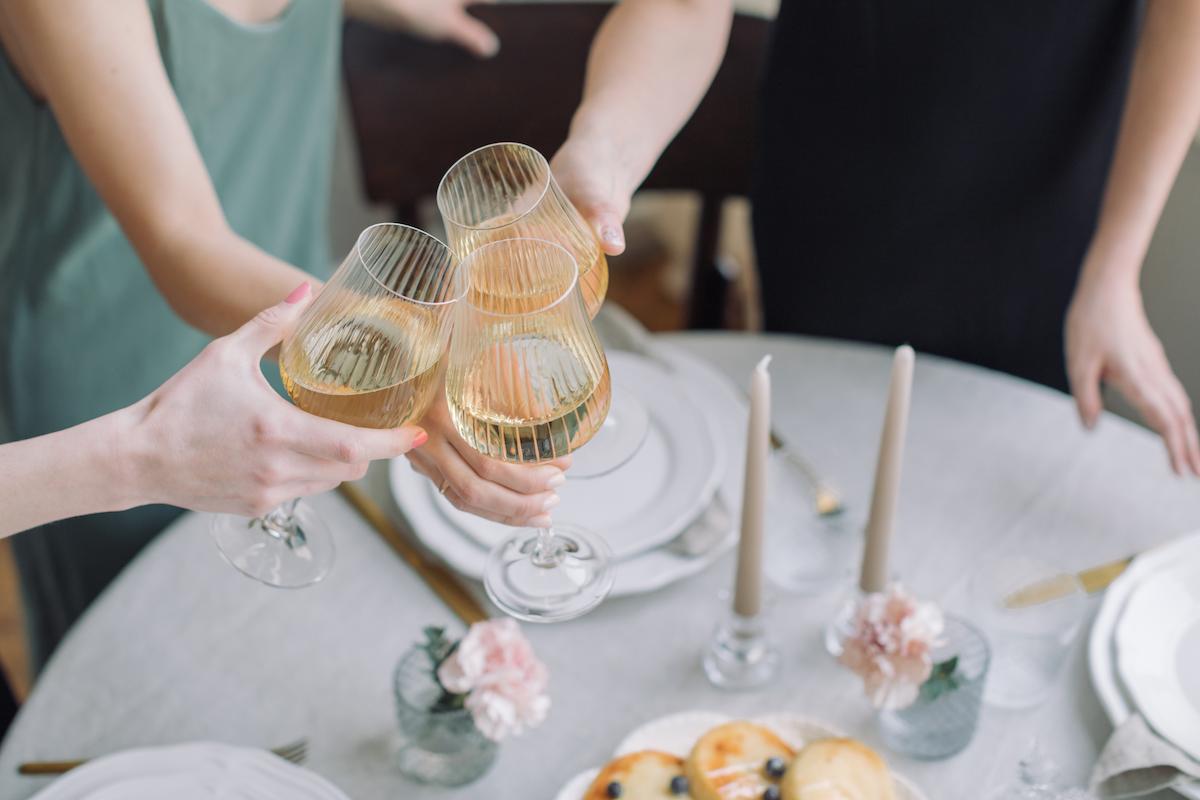 Wedding party. Hands holding glasses of champagne toasting.