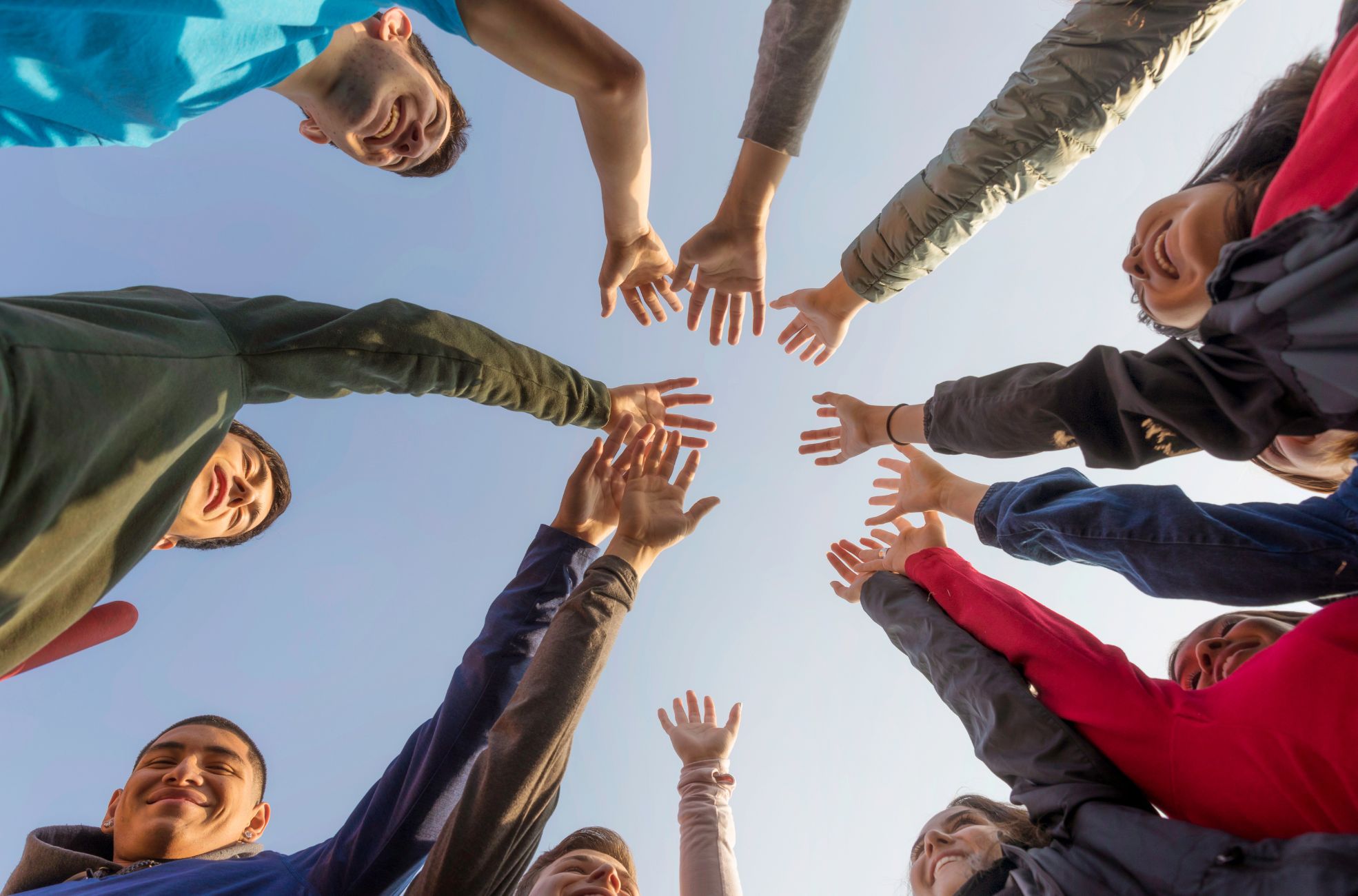 Community Members Holding hands In Air Together 