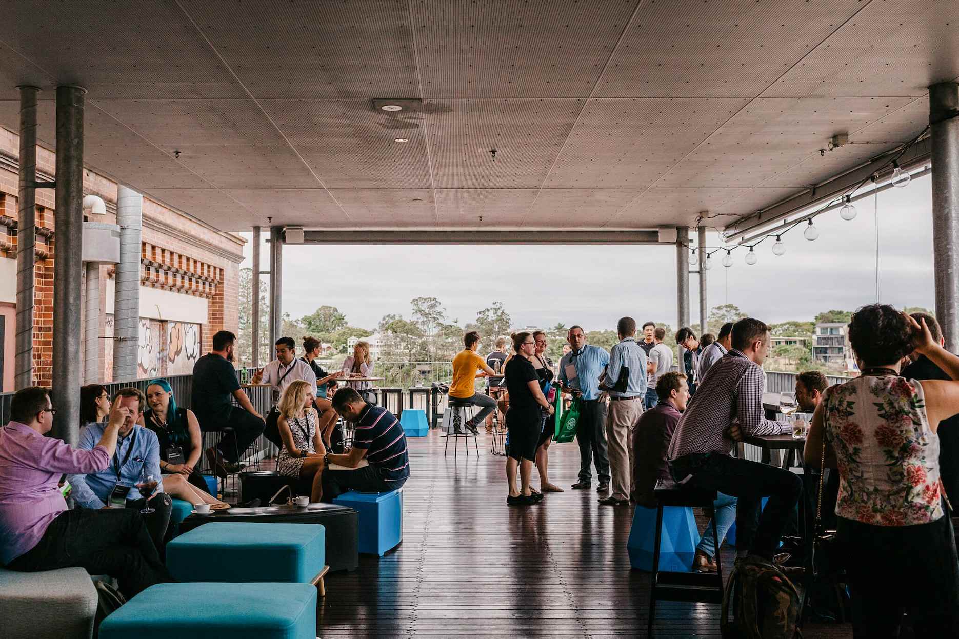 A gathering of people at Brisbane Powerhouse rooftop terrace.