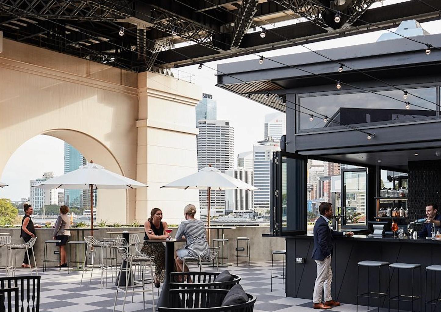 Guests sitting and having a drink at Fiume rooftop bar.