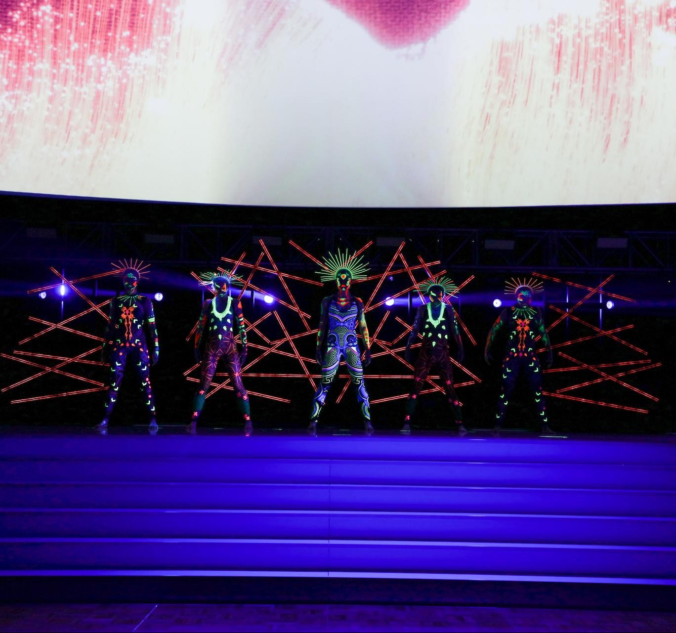 Professional dancers on stage performing a dance light show. 