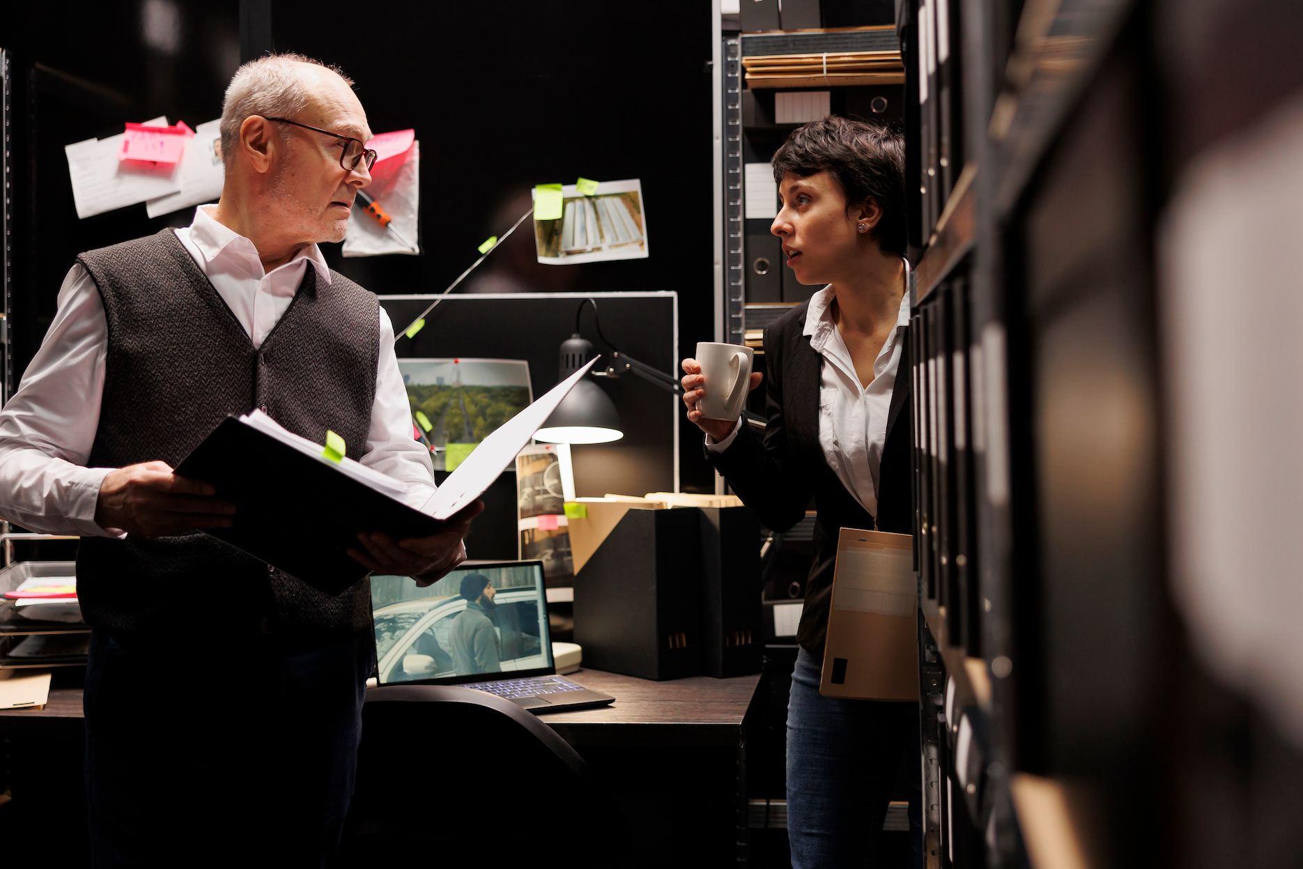Stage management team reviewing event plans backstage before a live production.