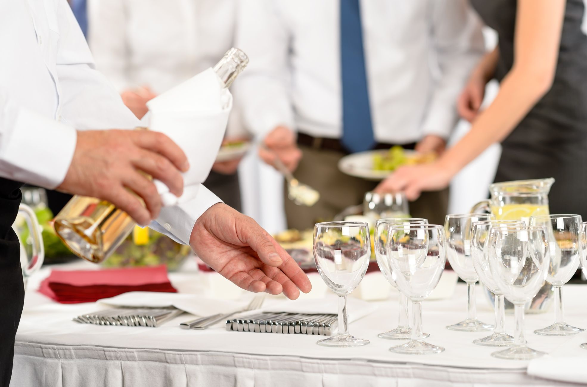 People Serving Alcohol At Event