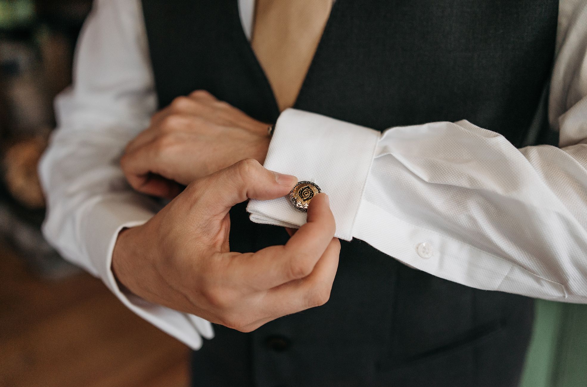 Man Putting On Cufflinks