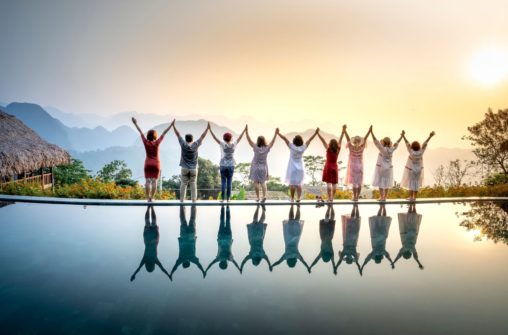 People Facing Sunrise Next To Pool