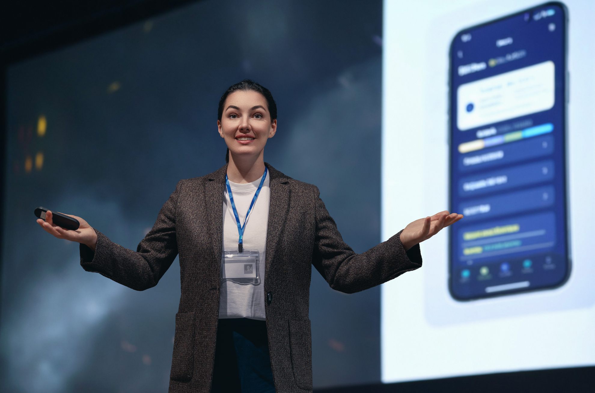 Plan-a-Product-Launch-Event Presenter showcasing a new mobile app at a product launch event.