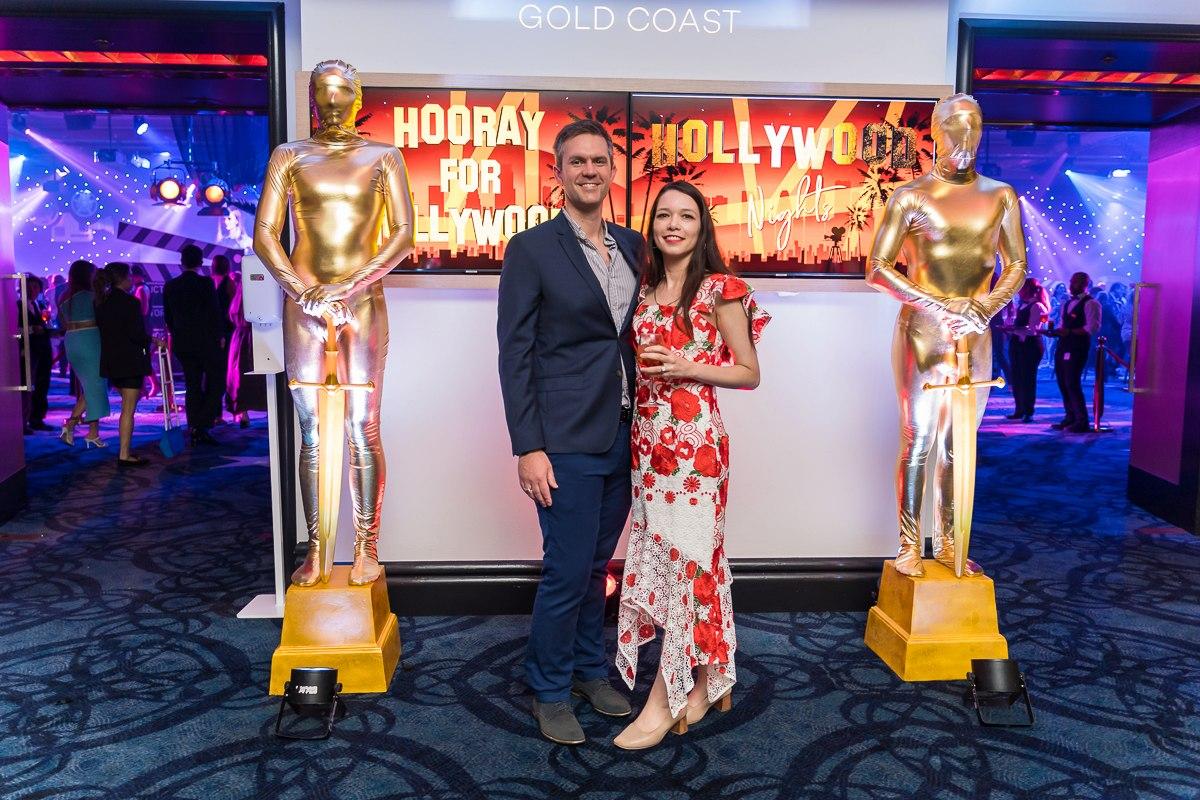 Corporate event guests with gold feature performers at a Hollywood-themed Gold Coast function.