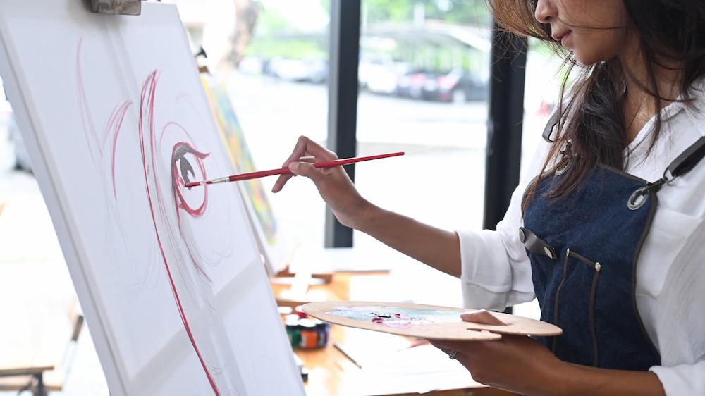 Close up of a canvas where the artist is doing a live painting