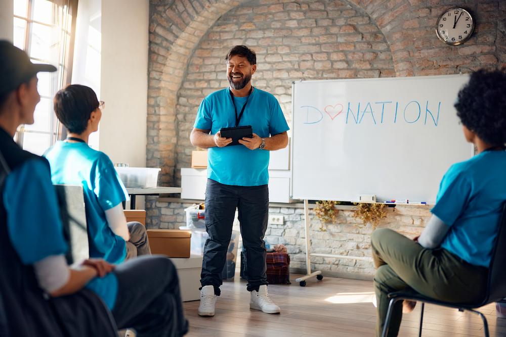Facilitator at the front of a modern office space getting ready to facilitate audience participation games