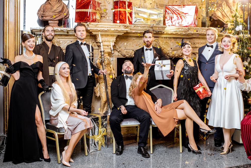 Group of colleagues dressed in fancy clothes as part of a murder mystery corporate event