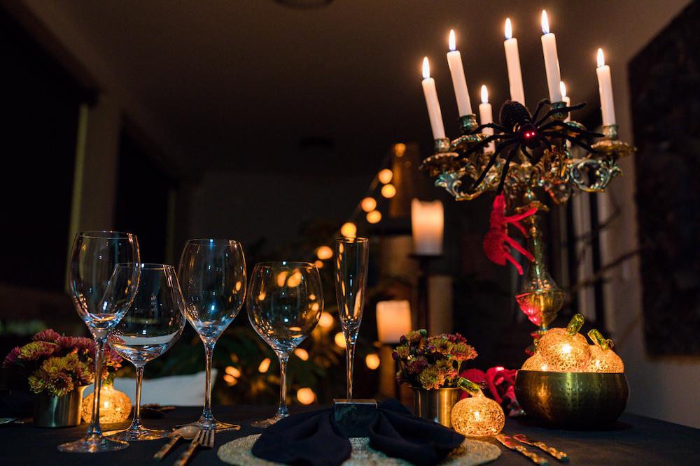 A dark room decorated with candelabras for a murder mystery corporate event