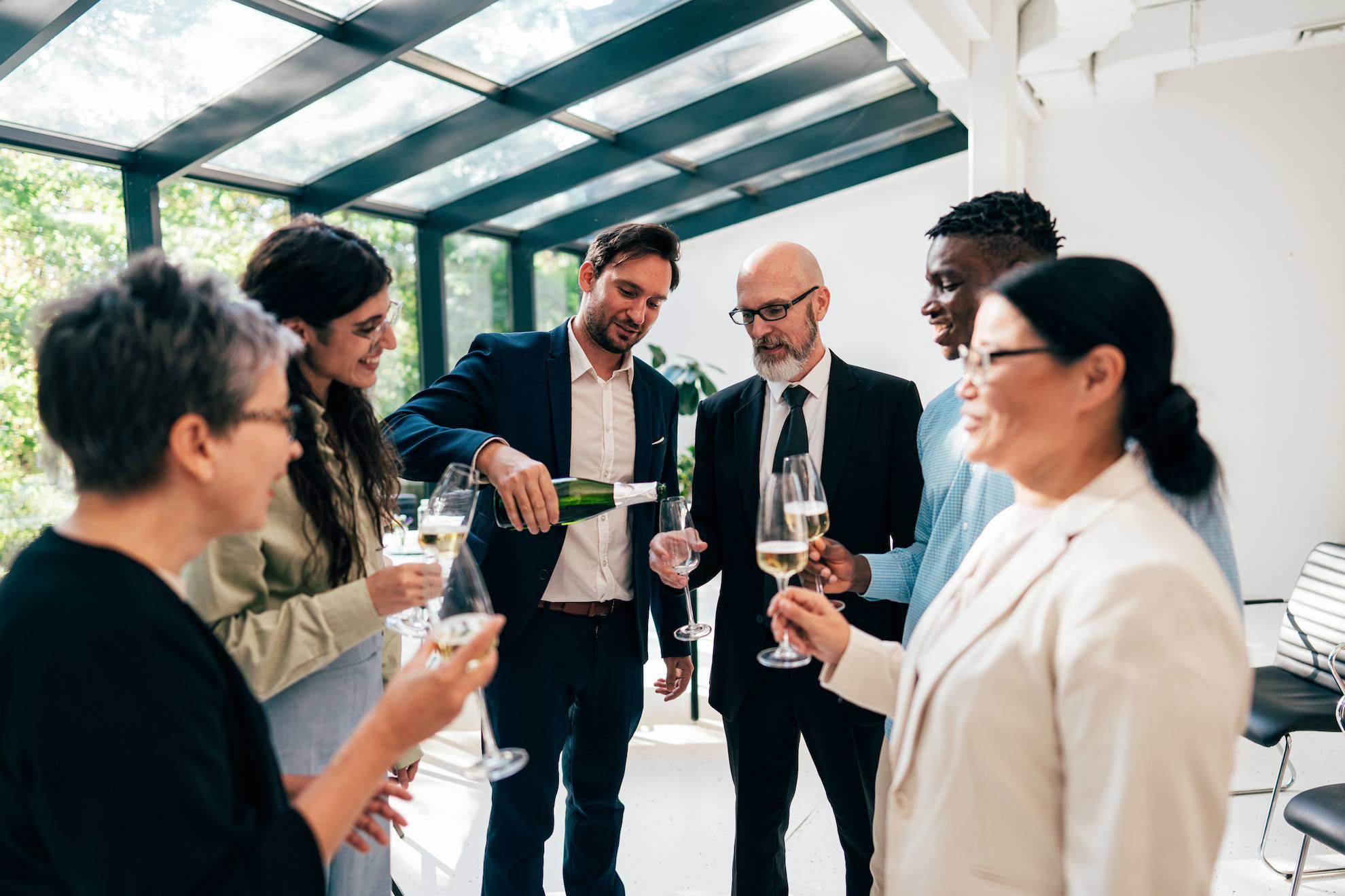 Business professionals networking over drinks at a corporate event.