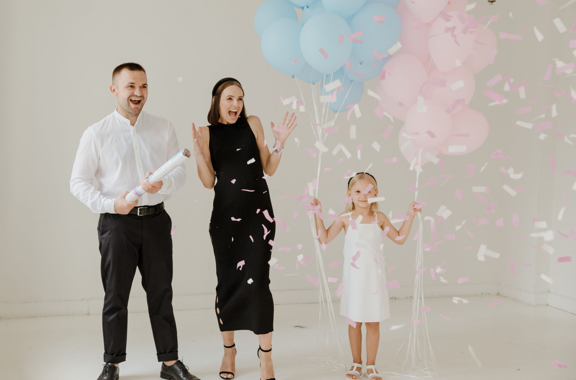 Man, Woman And Child Celebrating Gender Reveal