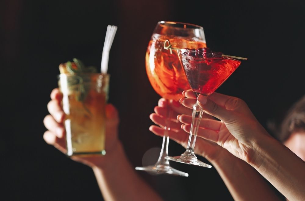 People Holding Drinks