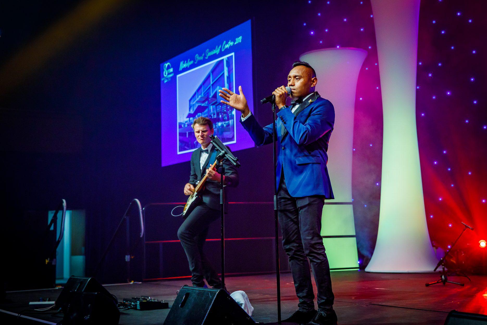 Live musicians performing on stage at a corporate function.
