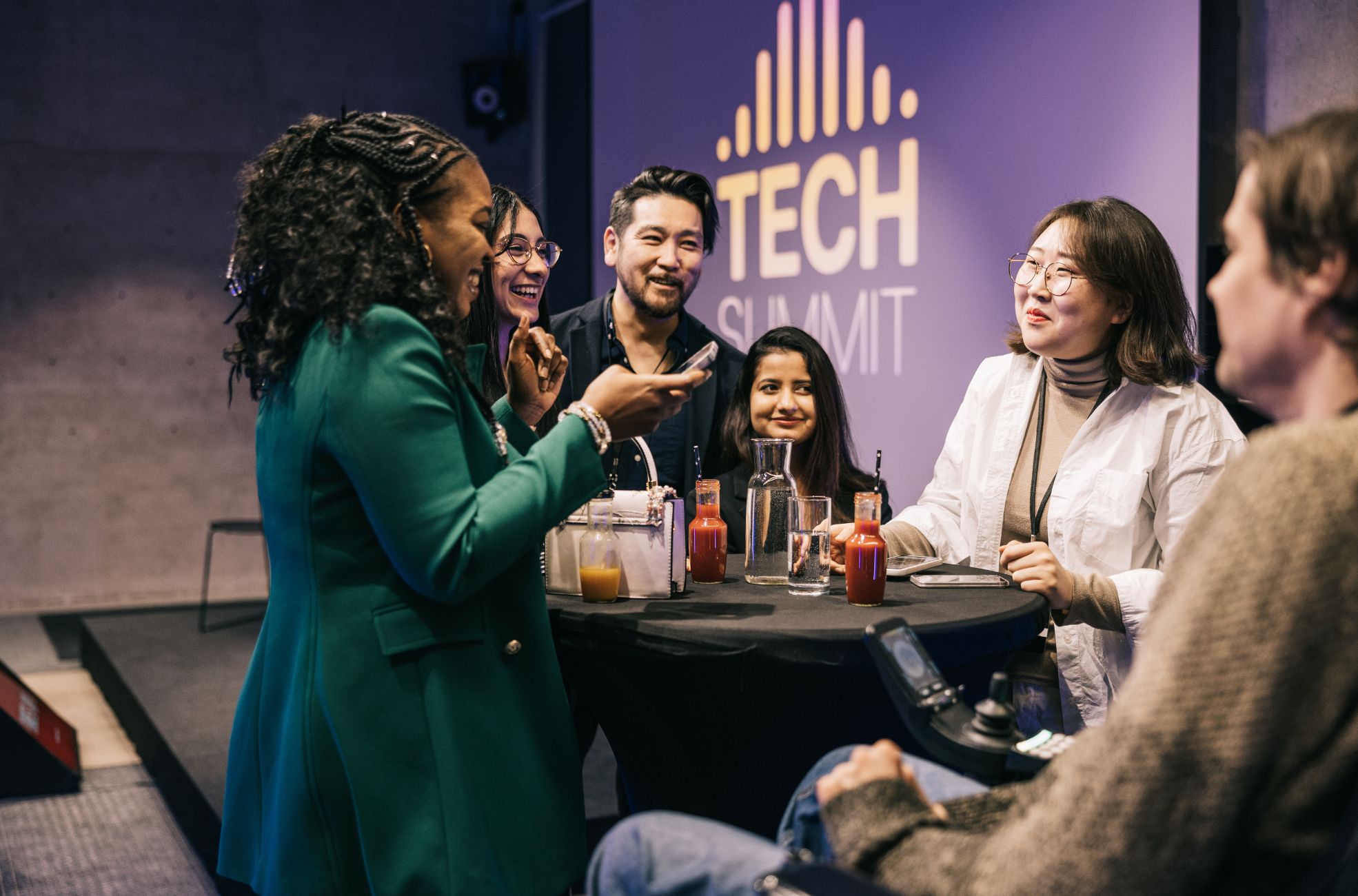 Woman Talking To Table Of People