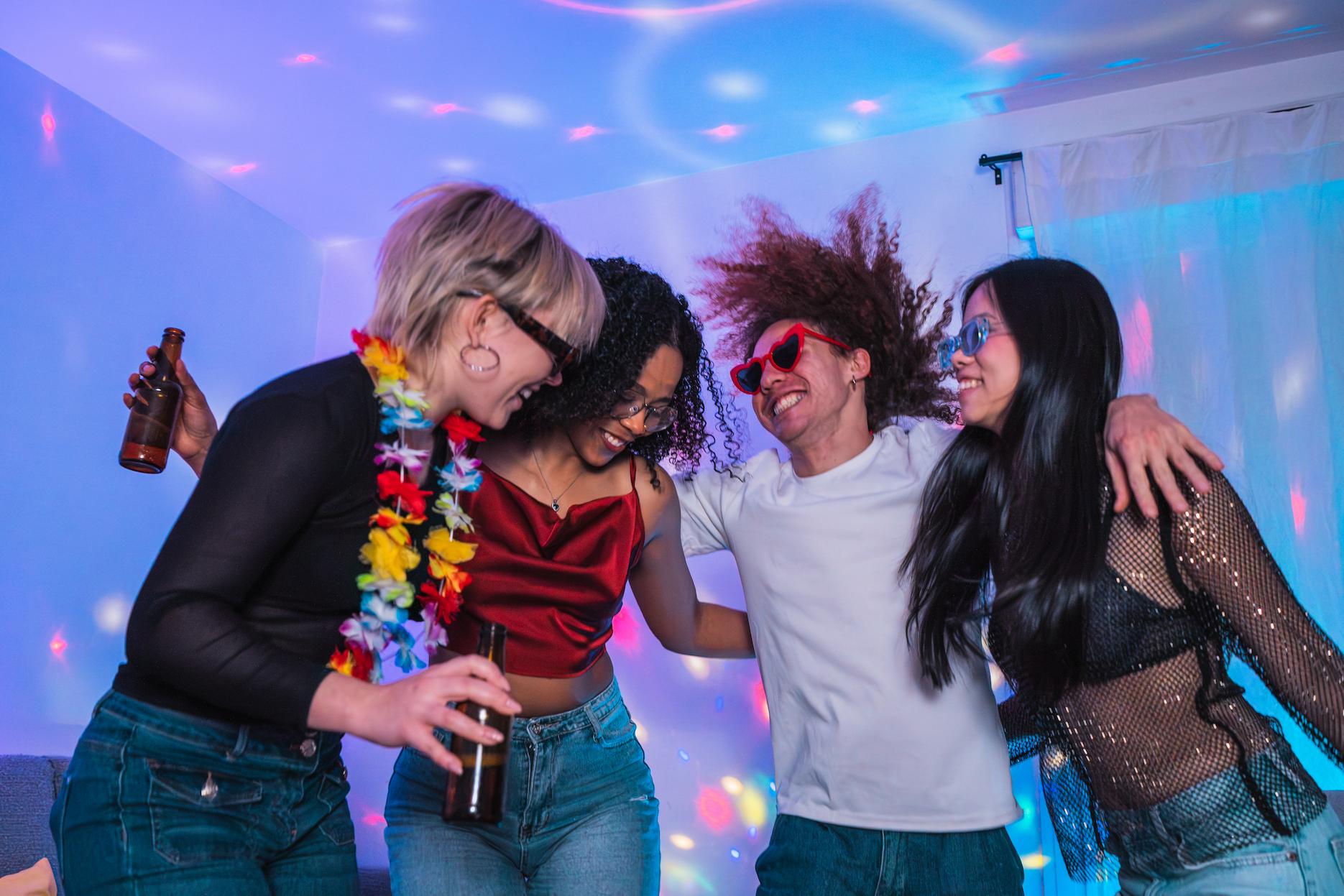 Friends celebrating a 21st birthday at home, with fancy dress up.