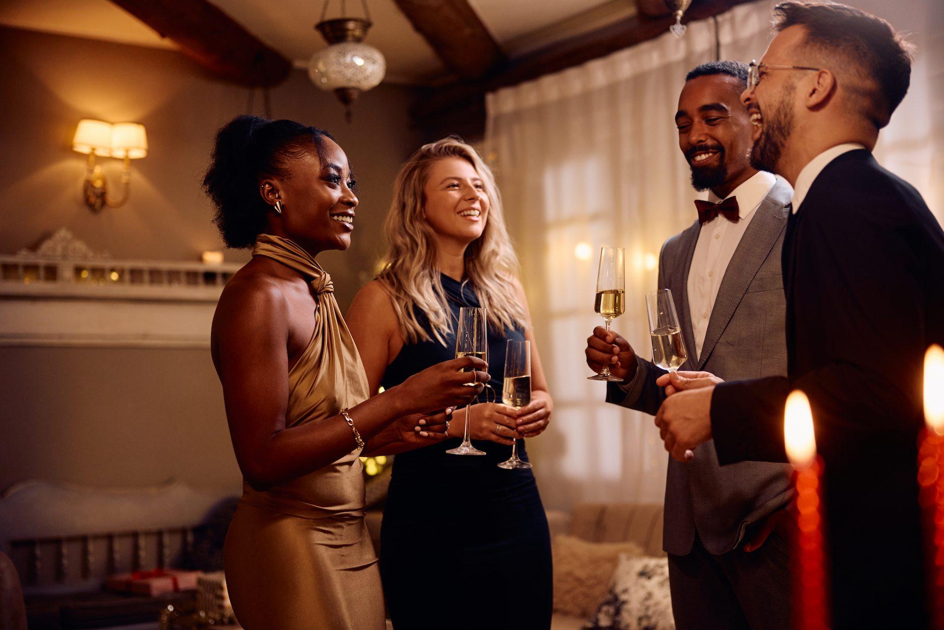 Guests celebrating a 40th birthday party with champagne at a stylish house party.