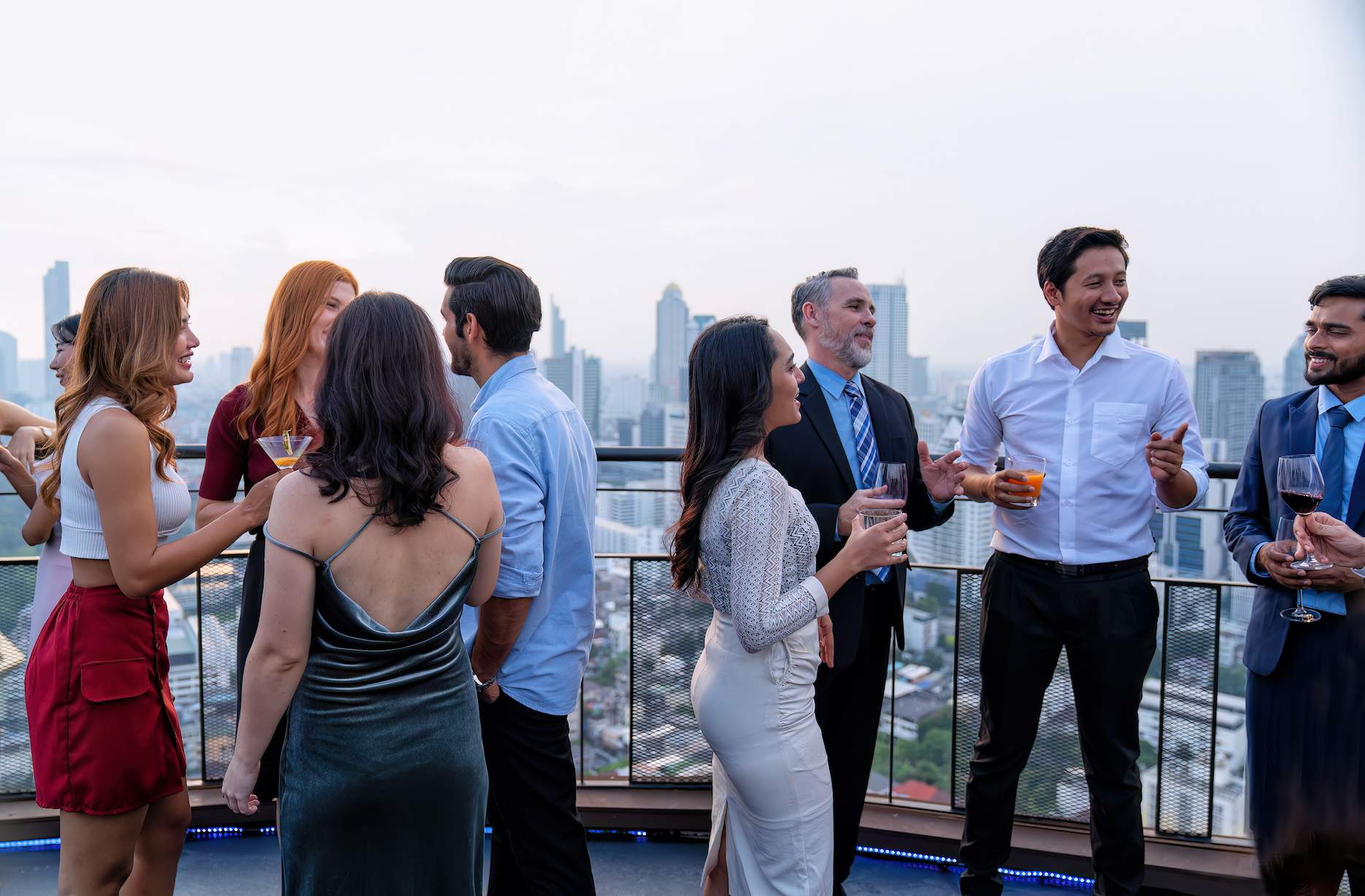 Staff-Party-Ideas-5 Staff party guests enjoying rooftop drinks at a city venue.