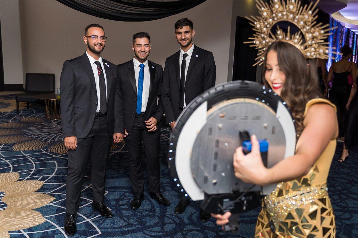 Roving photo booth entertainer taking photos with guests at a corporate staff party.