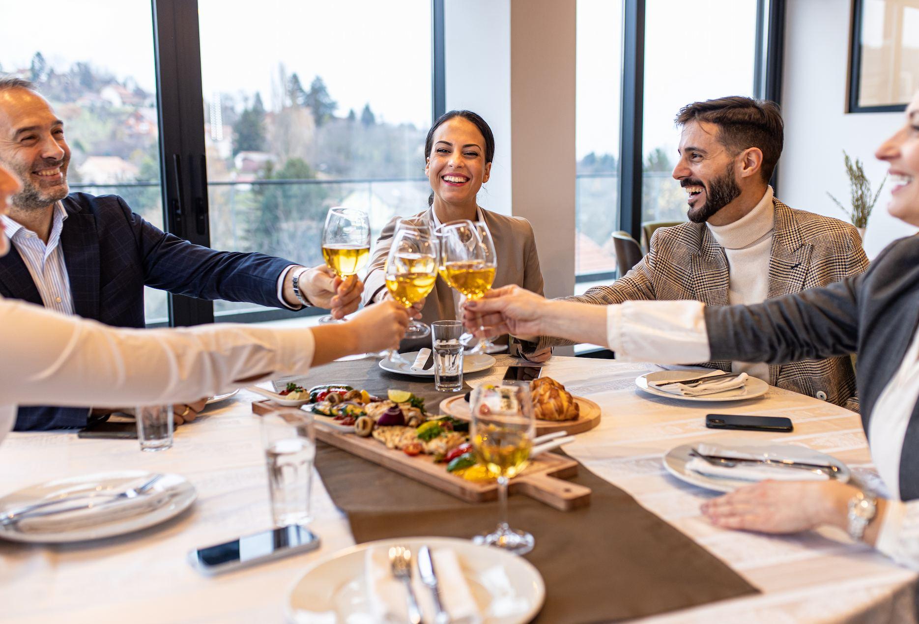 Business clients enjoying a private dinner and toasting together.