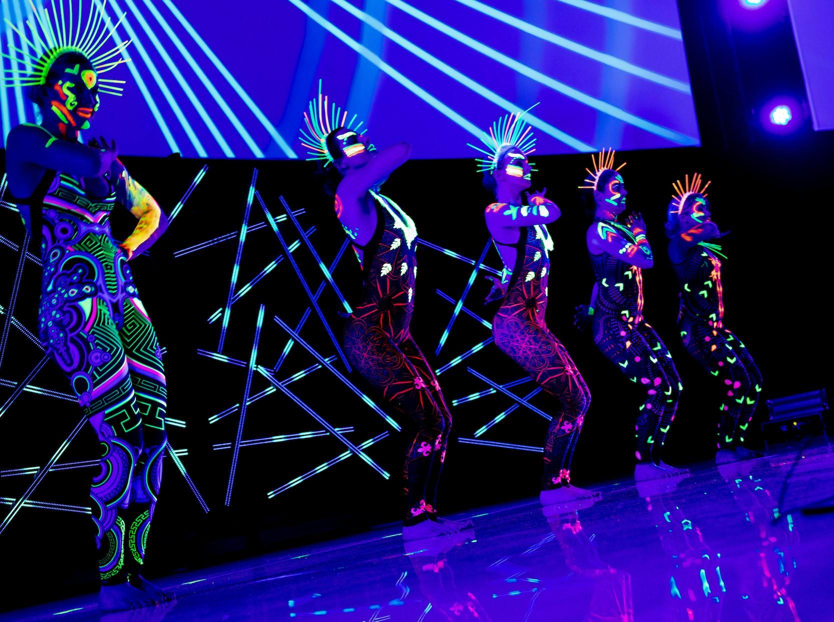 UV dancers performing a choreographed corporate event show.
