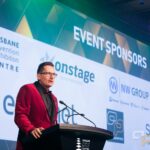 Professional MC presenting at a corporate event at Brisbane Convention & Exhibition Centre.