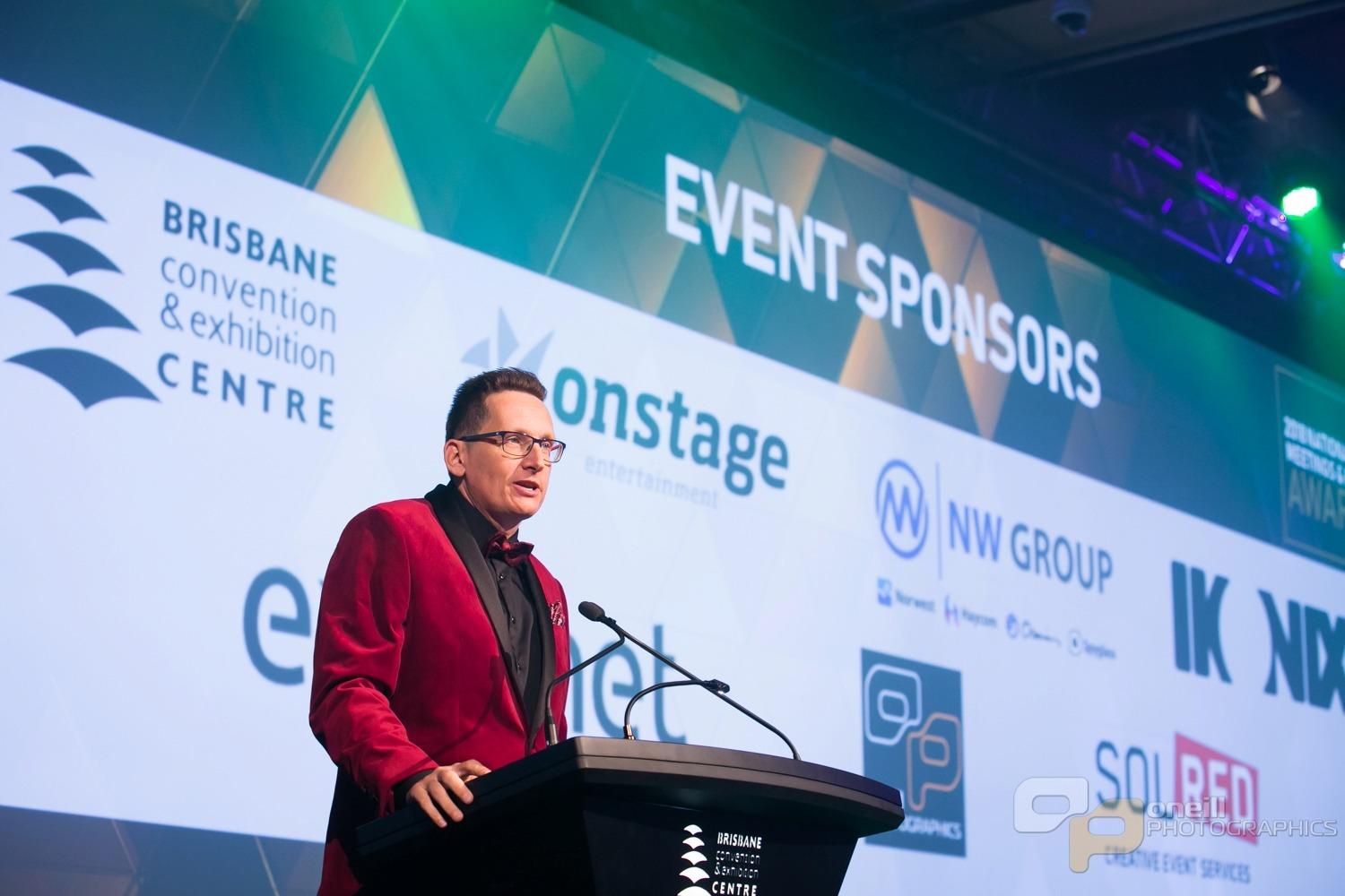 Professional MC presenting at a corporate event at Brisbane Convention & Exhibition Centre.